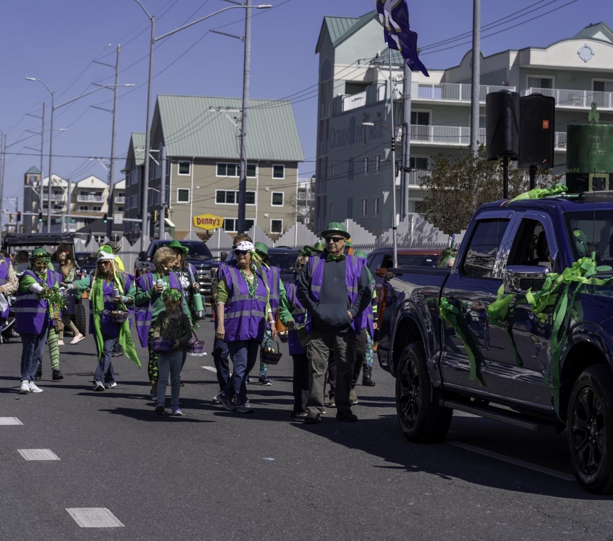 Raven's Roost Parade group Group of people wearing purple and green at the parade